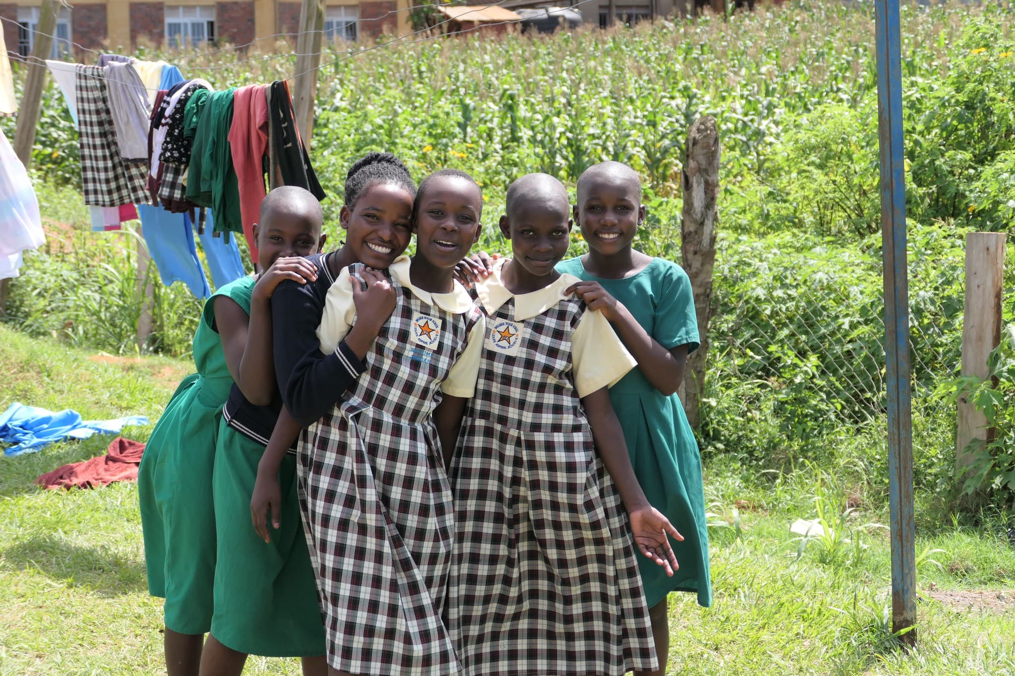 Five girls in Broader Vision School green and checkered uniforms